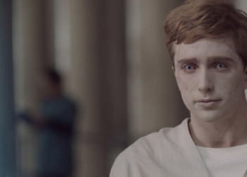 Jugendlicher mit fahler Haut, Zombieaugen und hellem Krankenhauskittel